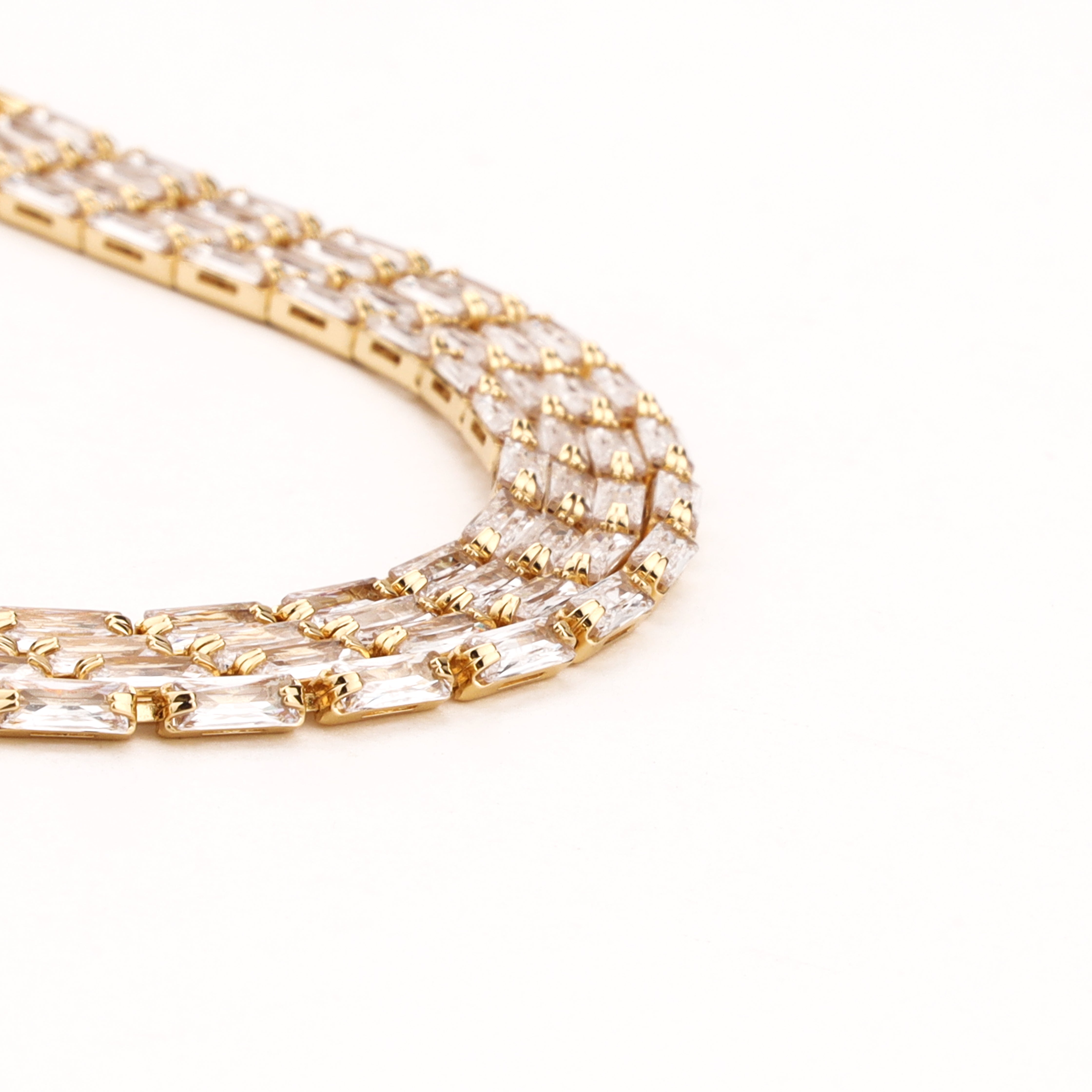 Valleria gold-tone tennis bracelet with twin baguette-cut clear crystal stones in linked settings