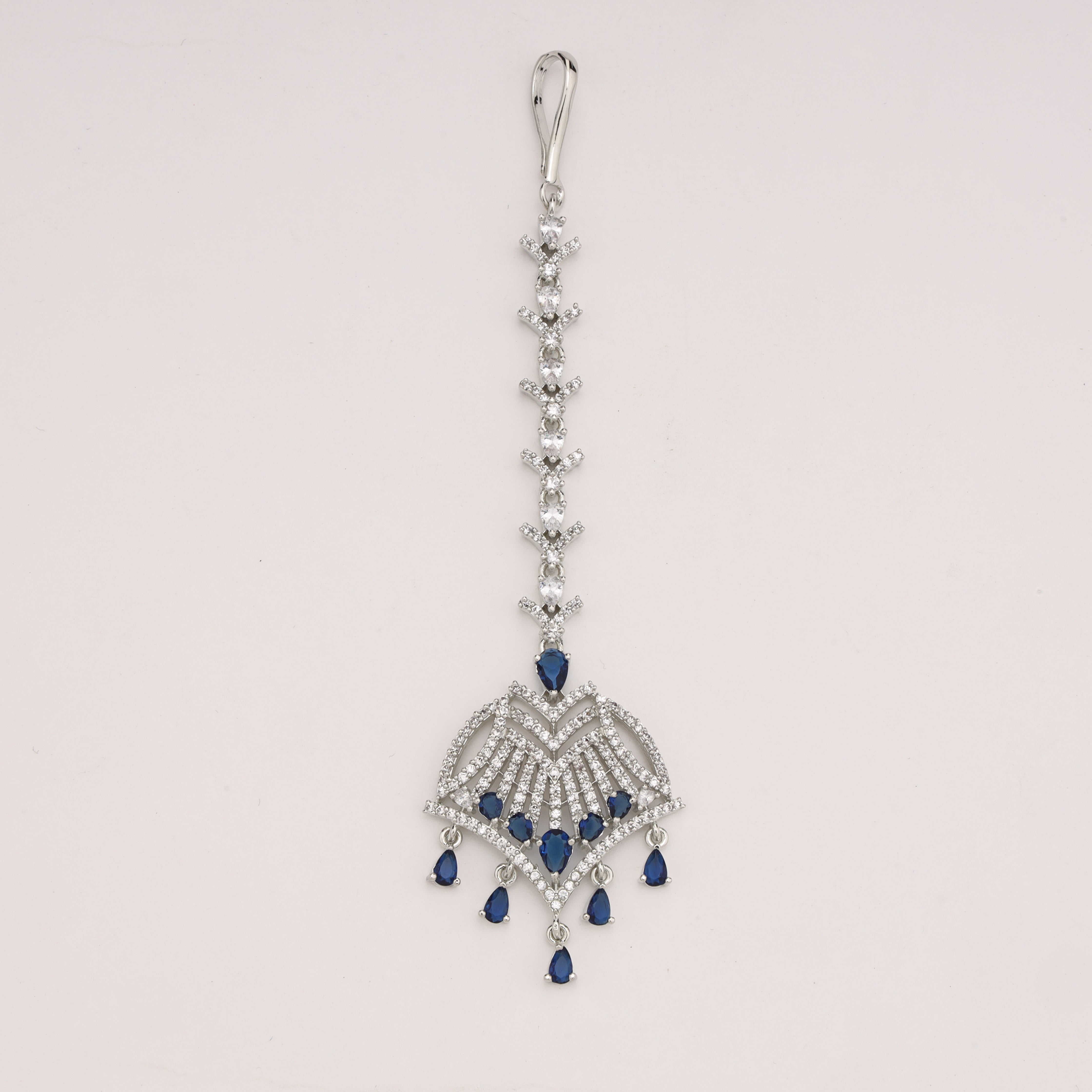 Sapphire Diamond Maang Tika with silver finish, cubic zirconia stones and blue teardrop accents for bridal and party wear by US Catalog