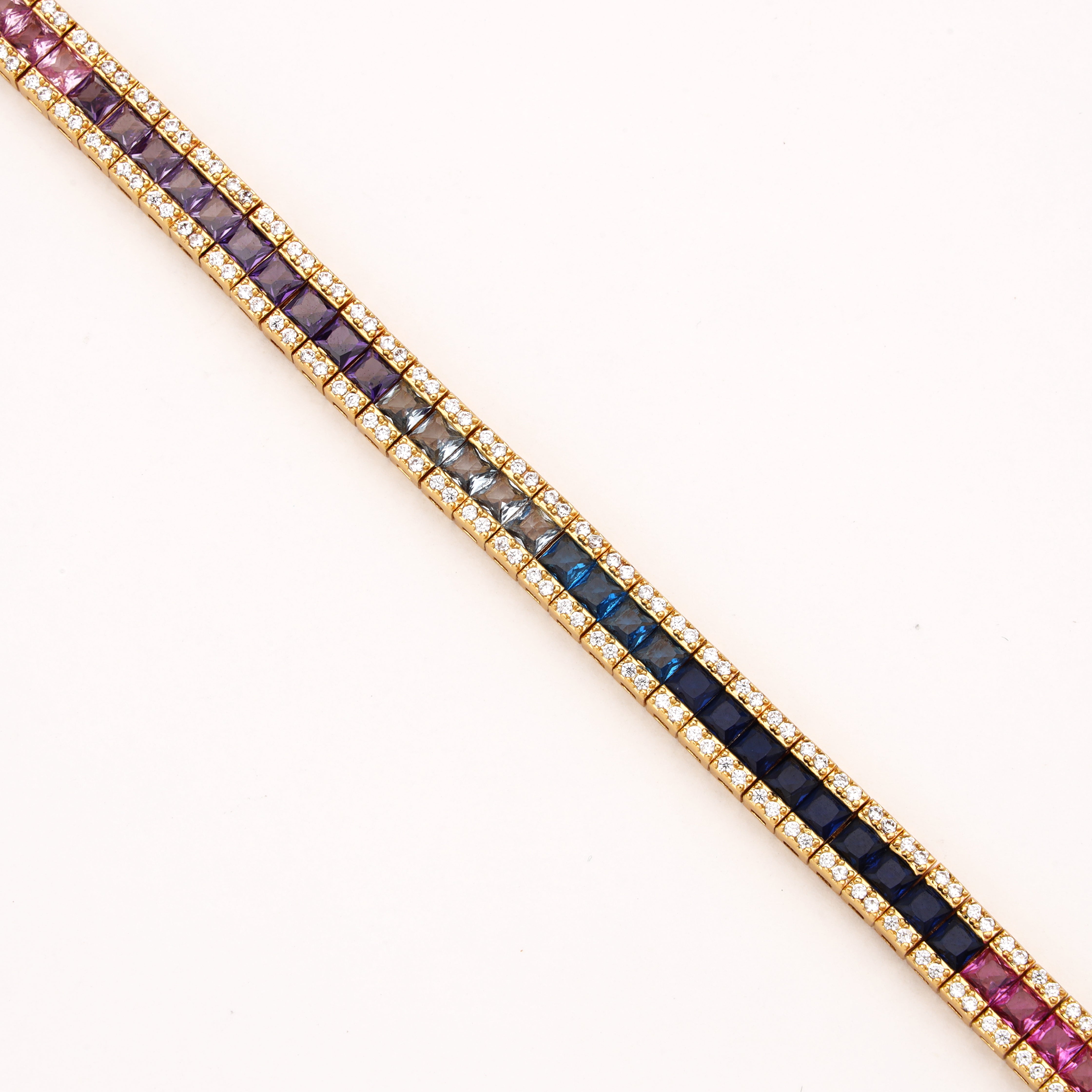 Rainbow gold-tone ombre crystal bracelet with purple, clear, aqua and deep blue square stones