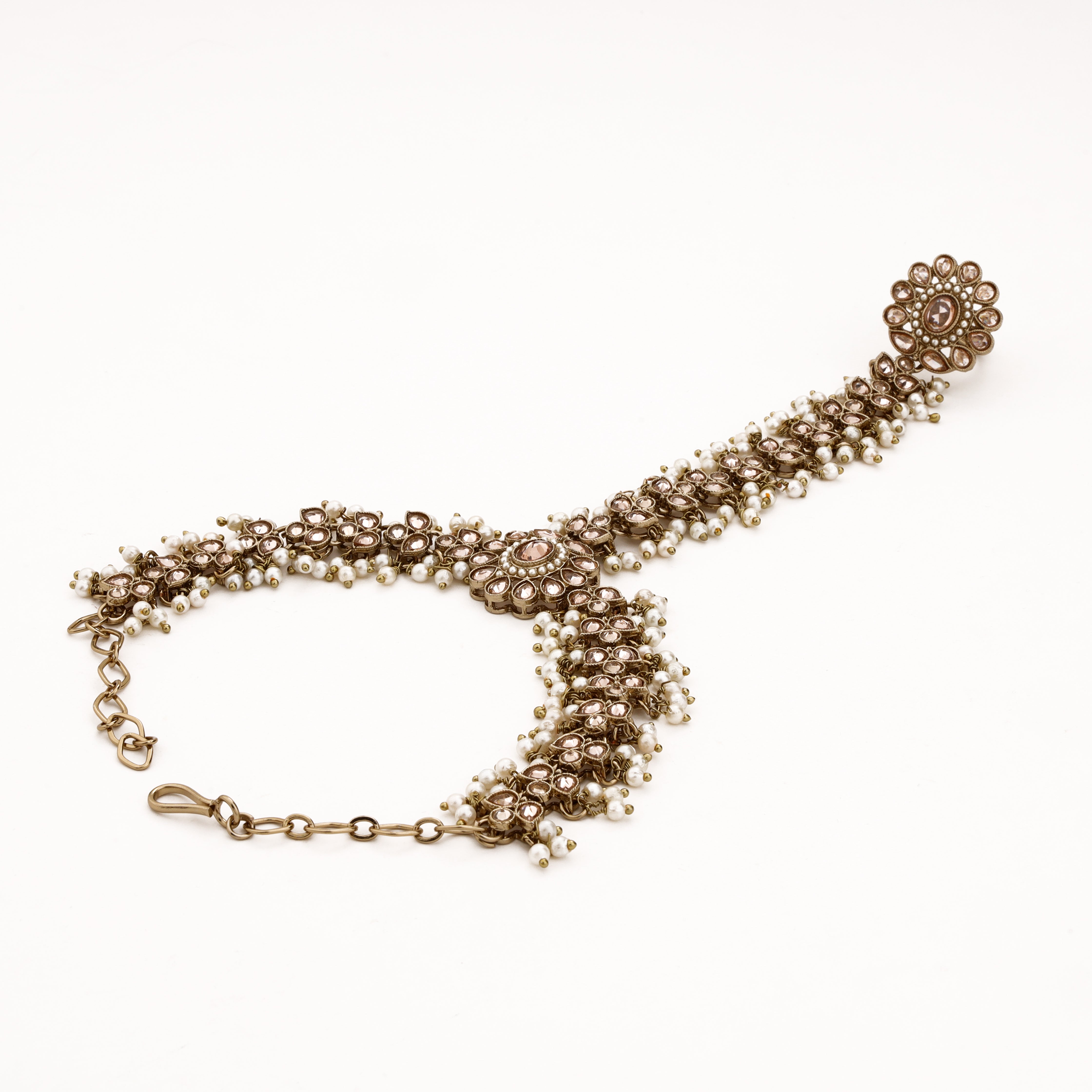Antique gold bridal pocha with champagne teardrop stones, white pearl fringes and adjustable wrist chain