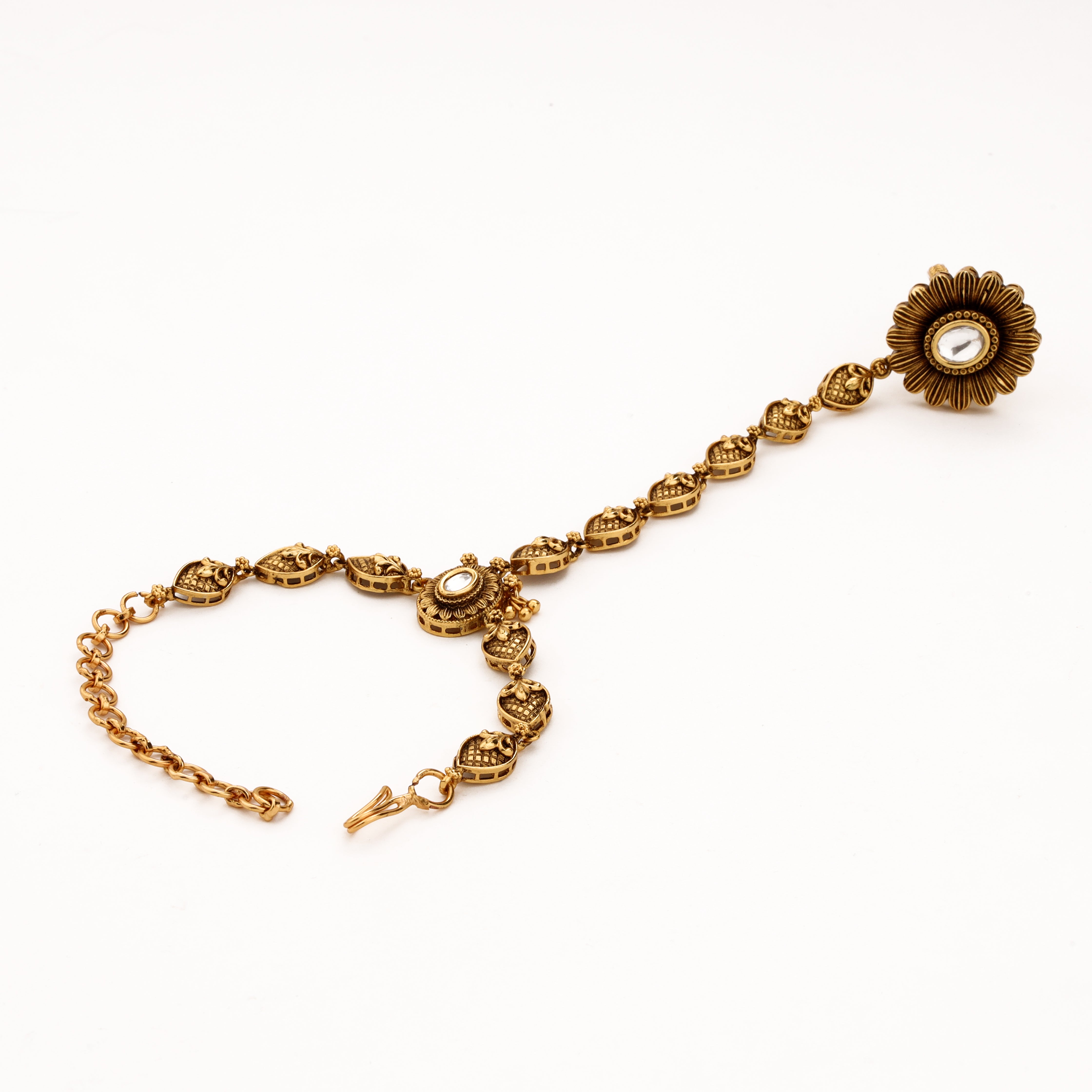 Antique gold floral pocha with engraved leaf links, white kundan-style stones and adjustable wrist chain