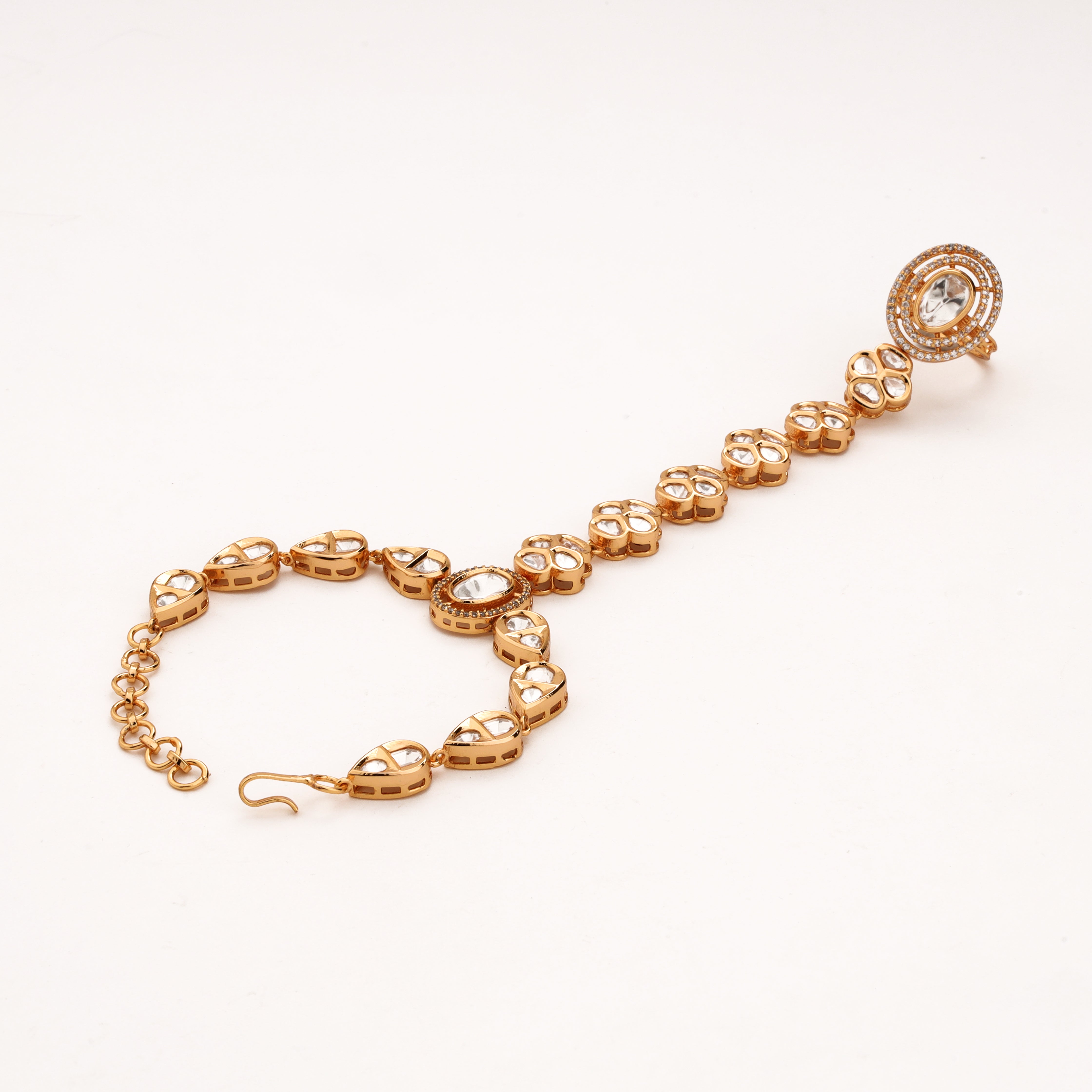 Gold-tone floral cluster kundan pocha with white stones, teardrop links and adjustable wrist chain