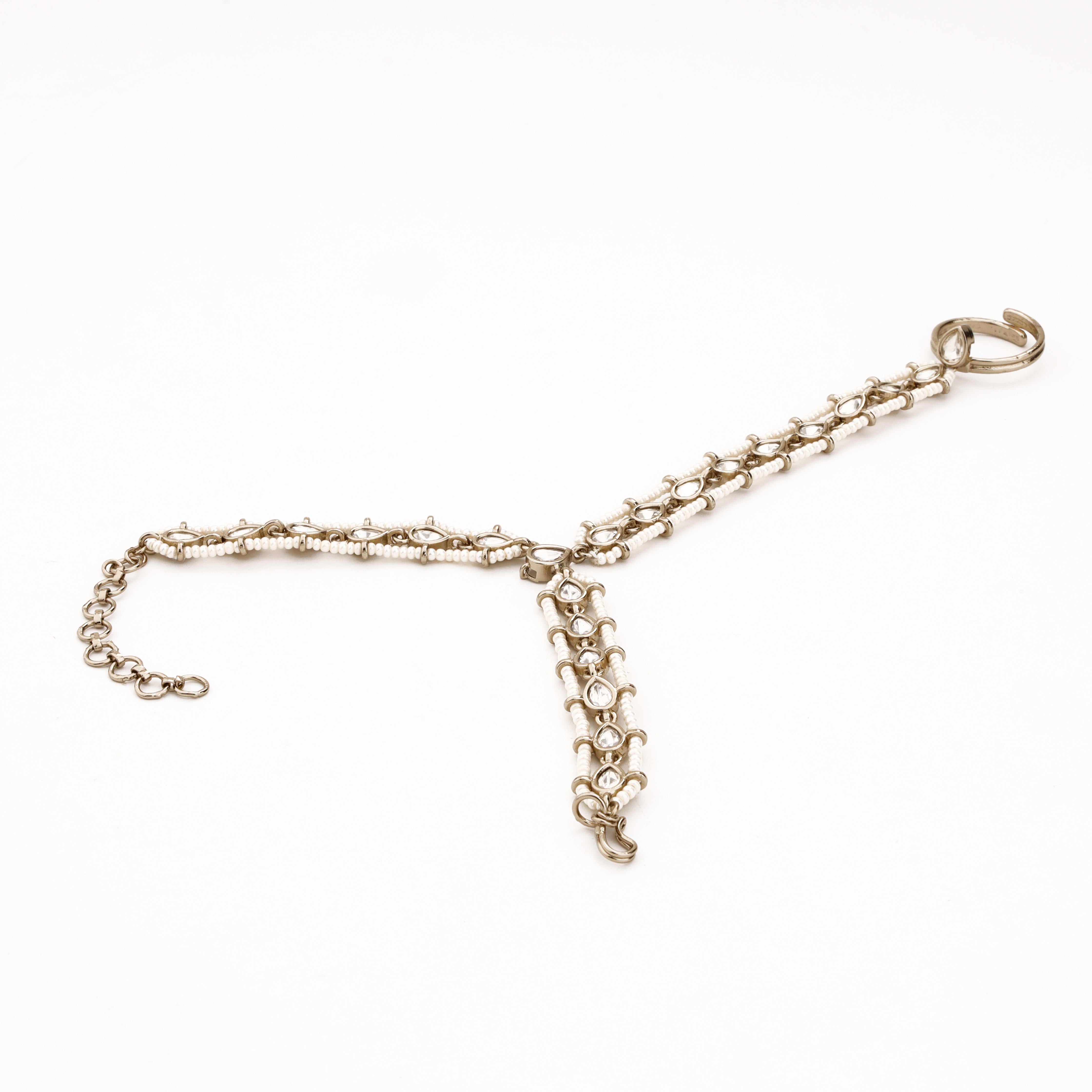 Silver-tone teardrop beaded pocha with clear stones, white bead rows, finger ring and adjustable wrist chain