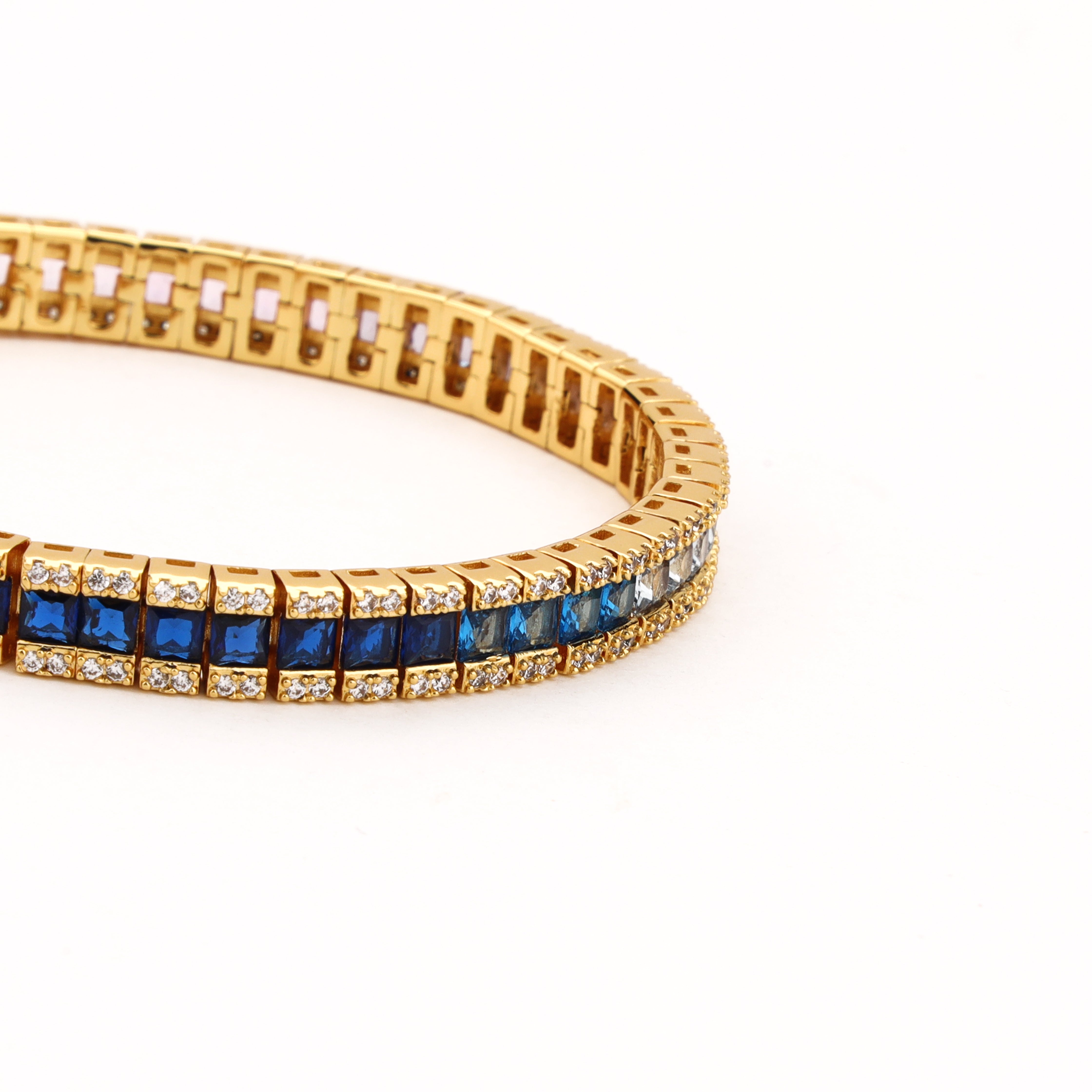 Rainbow gold-tone ombre crystal bracelet with purple, clear, aqua and deep blue square stones