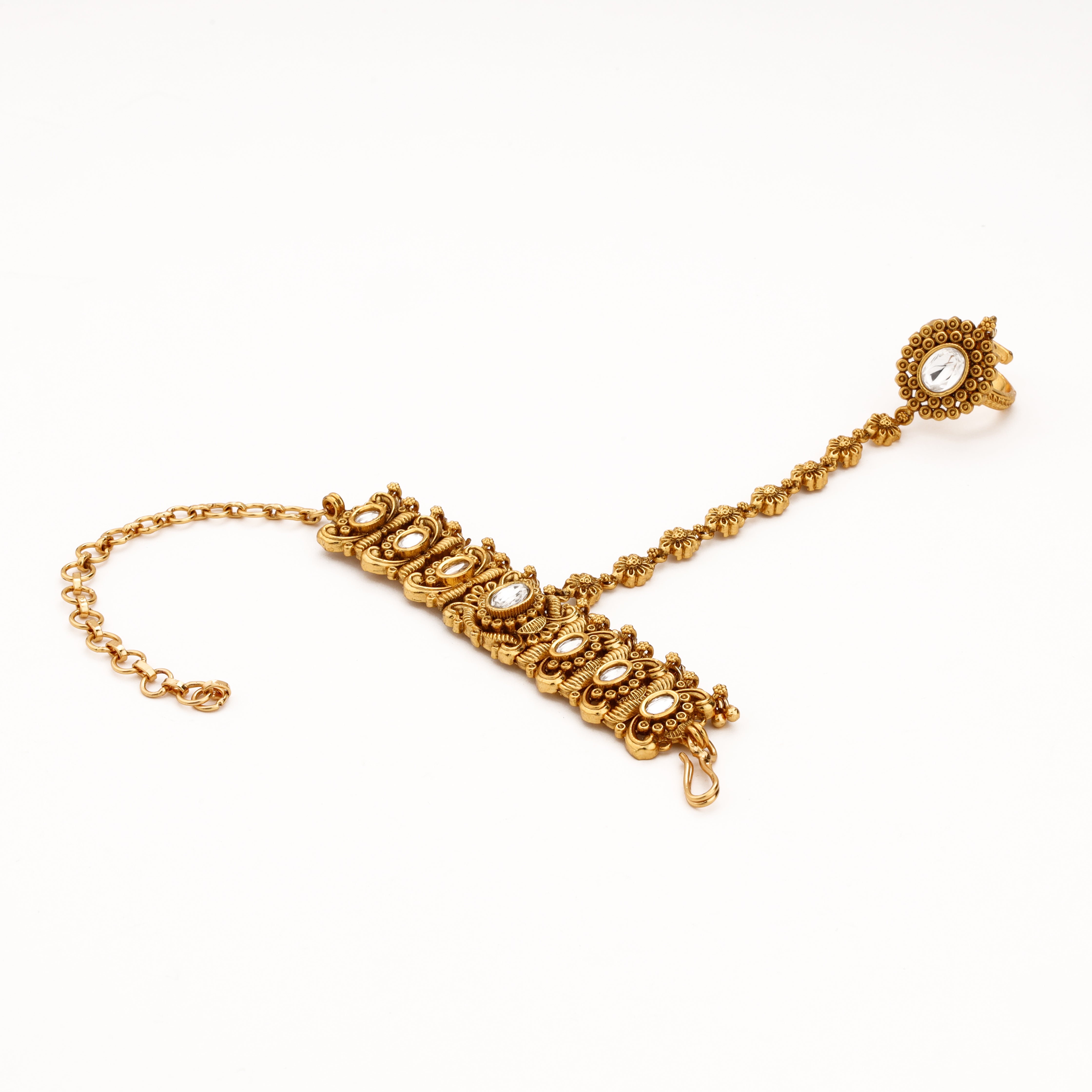 Antique gold oval kundan floral pocha with ornate wrist design, hand chain and statement finger ring