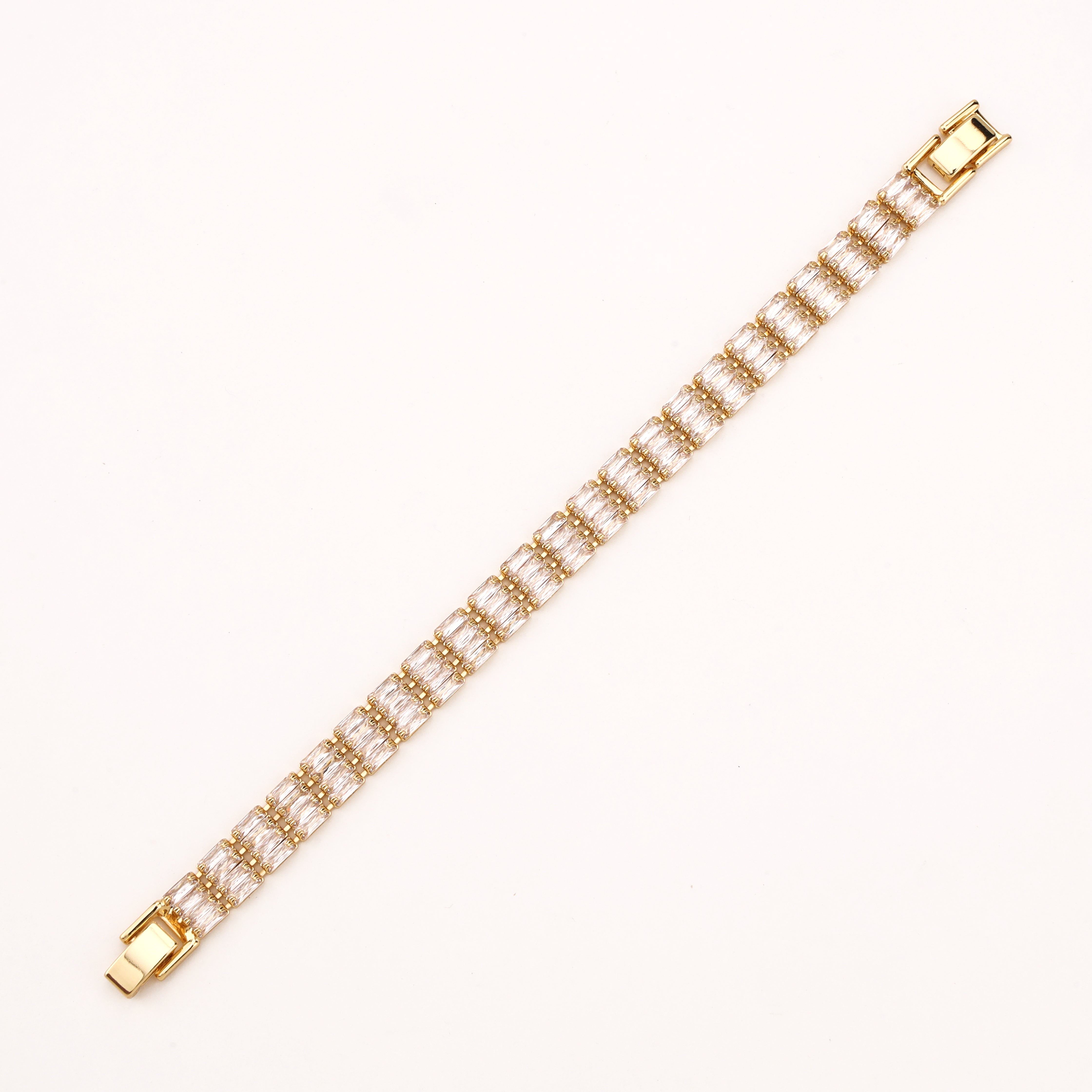 Valleria gold-tone tennis bracelet with twin baguette-cut clear crystal stones in linked settings