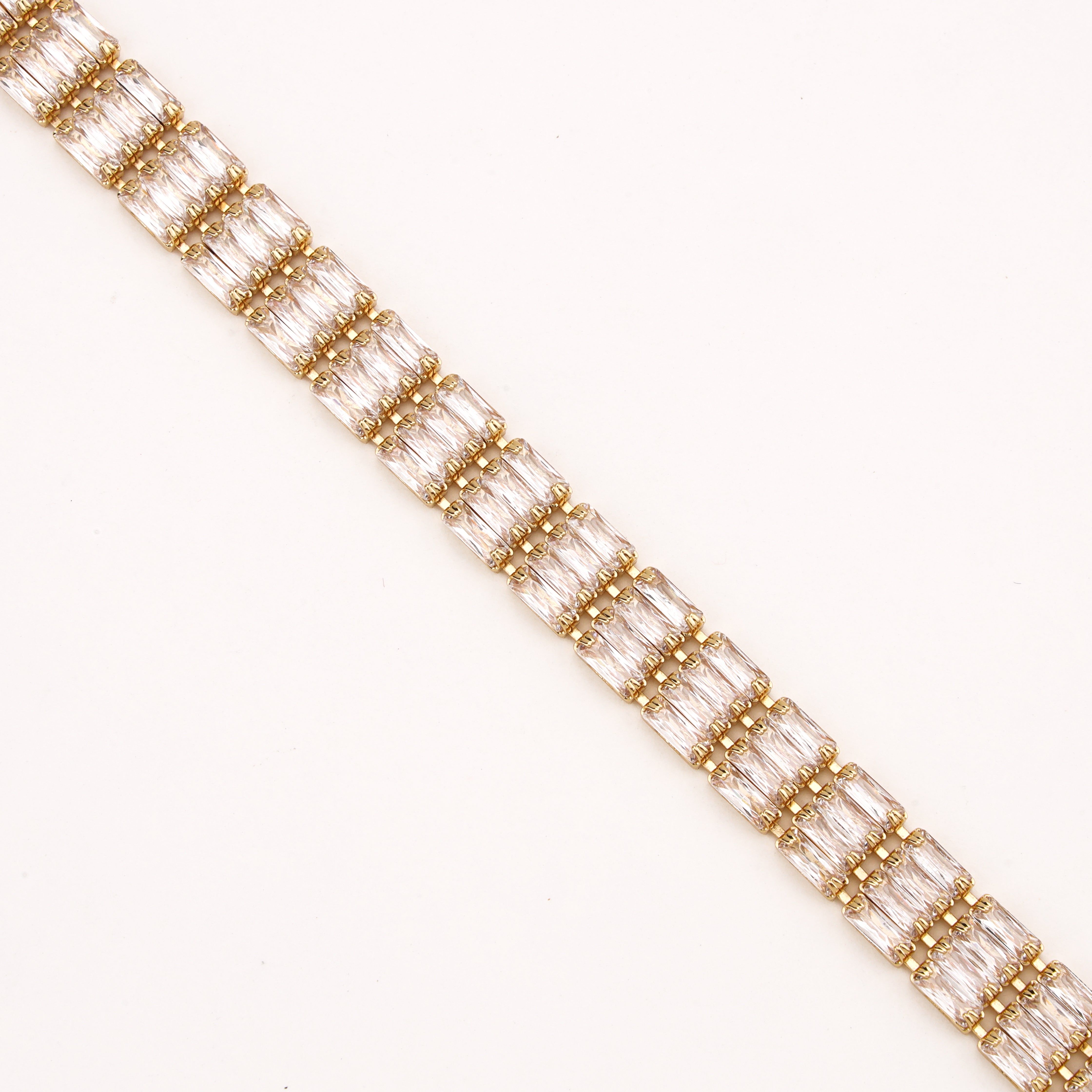 Valleria gold-tone tennis bracelet with twin baguette-cut clear crystal stones in linked settings