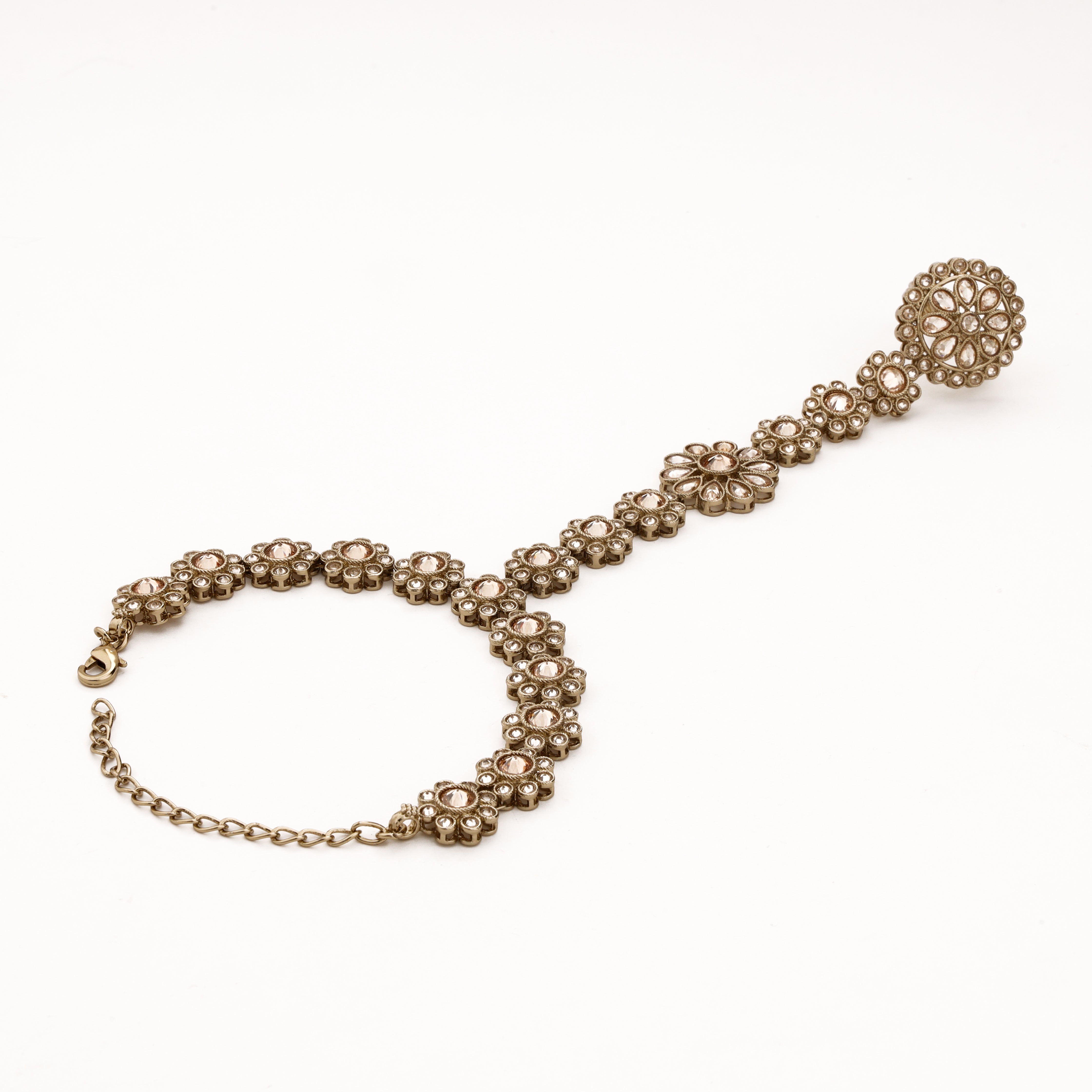 Champagne gold floral kundan pocha with crystal stone links, statement finger ring and adjustable wrist chain