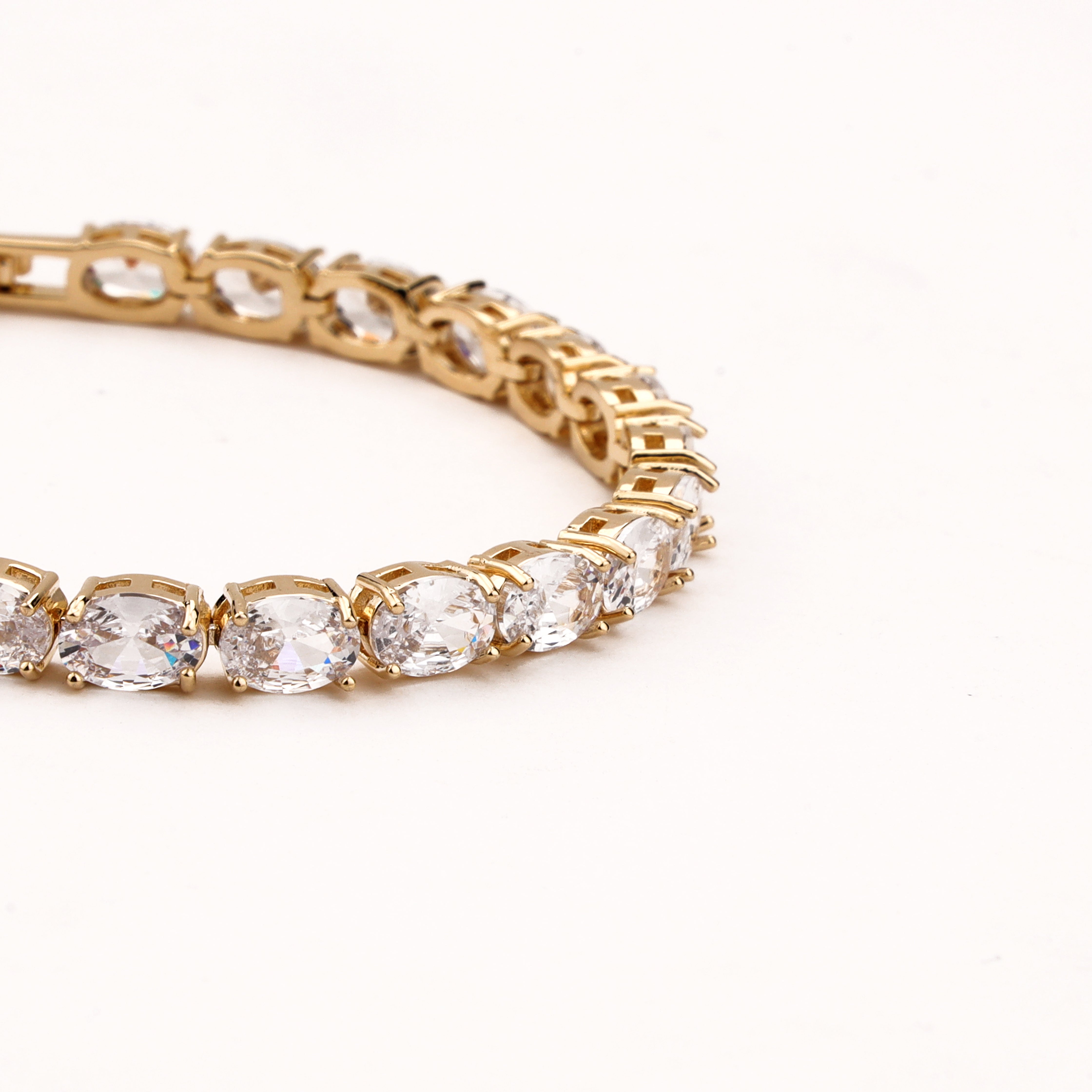 Marielle gold-tone tennis bracelet with a continuous row of oval-cut clear crystal stones