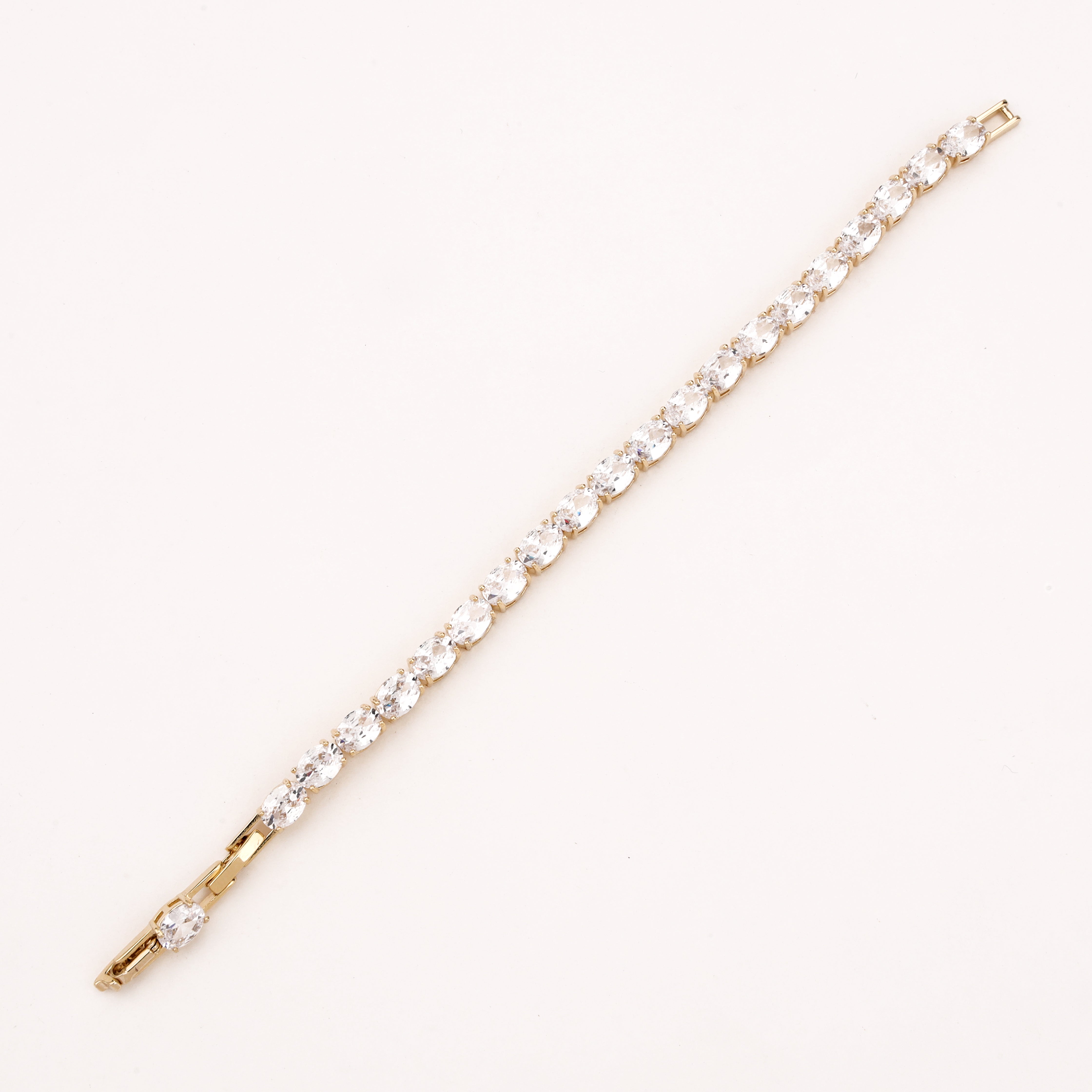 Marielle gold-tone tennis bracelet with a continuous row of oval-cut clear crystal stones