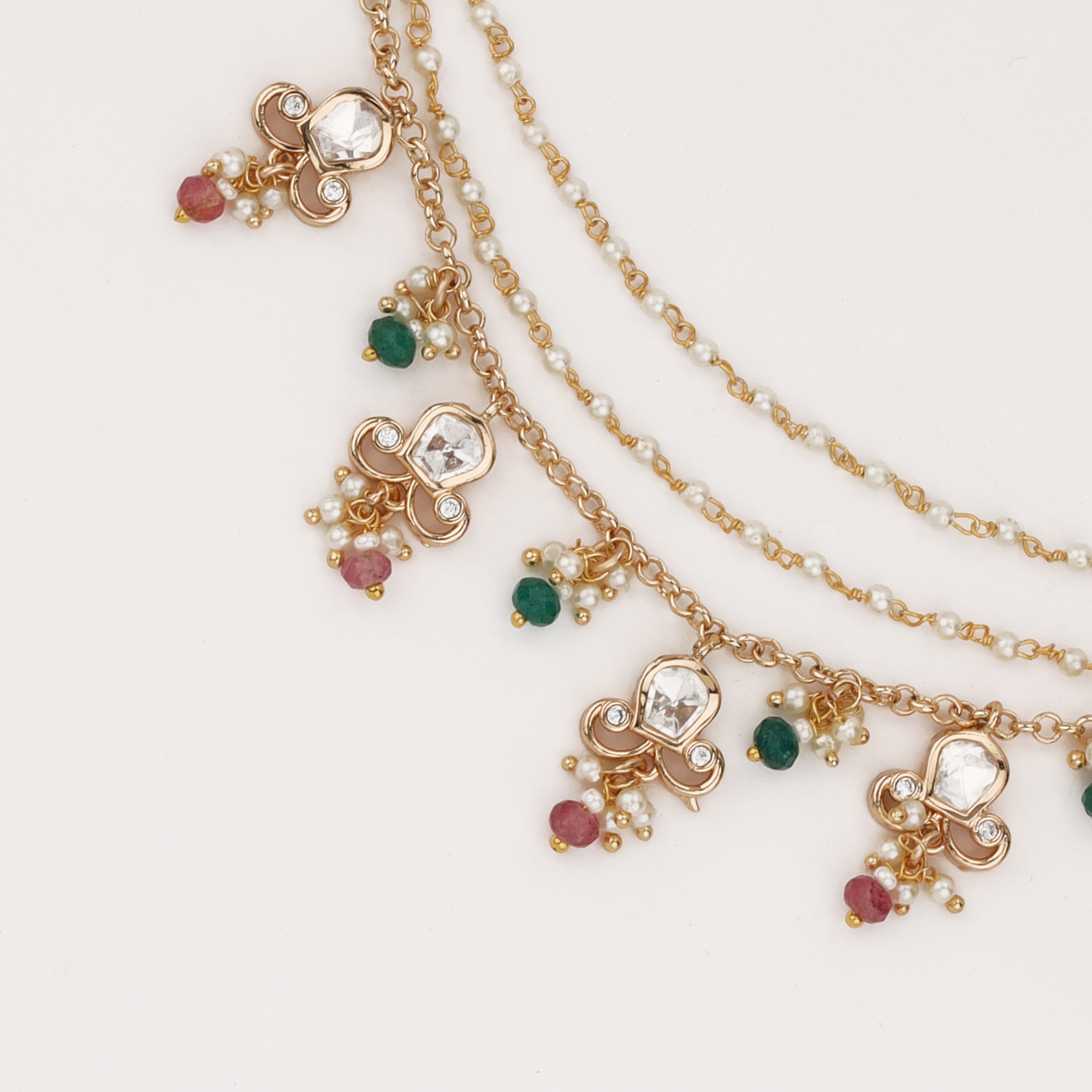 Regal multicolor charm ear chain with crystal motifs, pearl accents, and layered chains by US Catalog