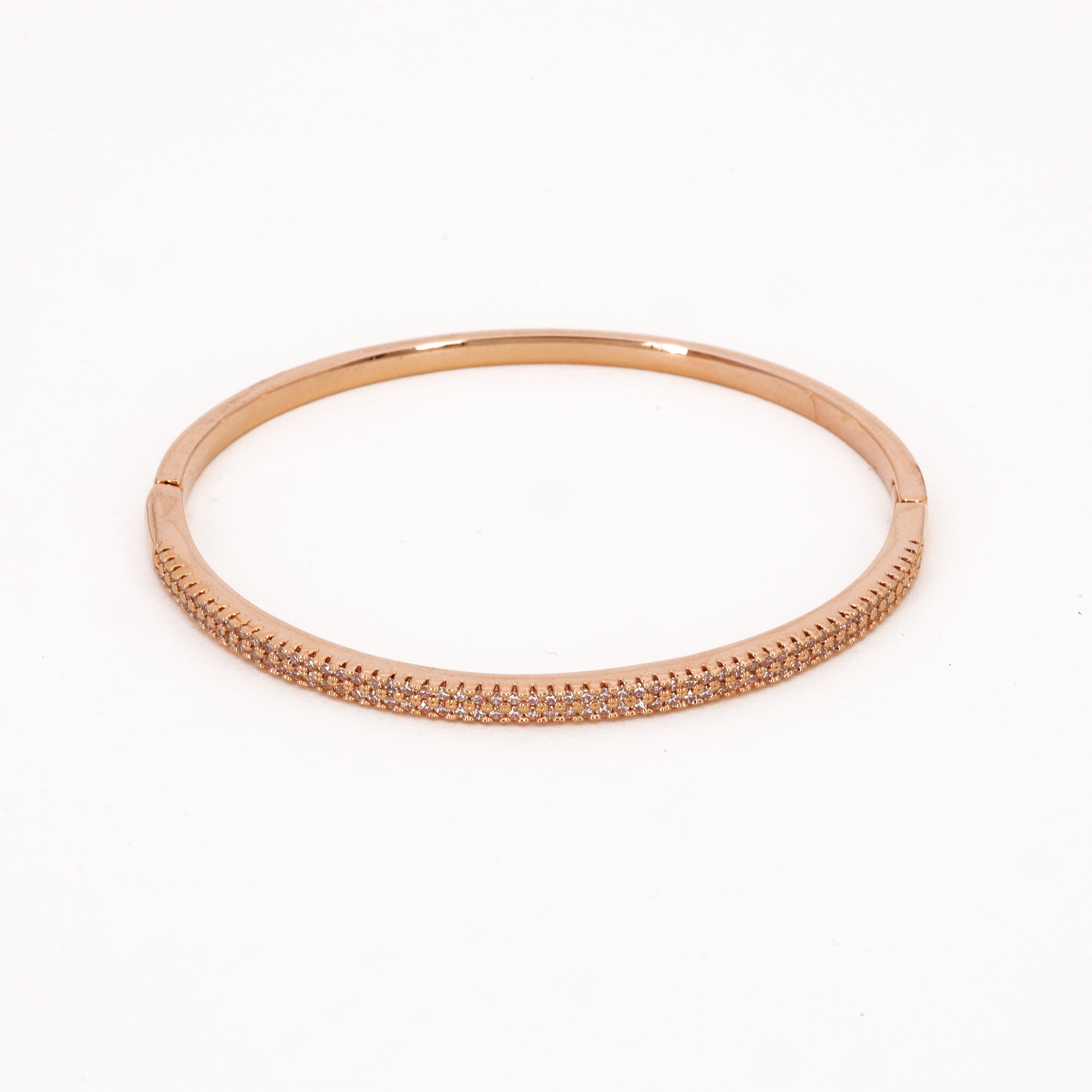 White Stone Swarovski Gold Tone Bangle Bracelet featuring dual rows of clear micro-crystals and a polished hinge finish on a white background for US Catalog.