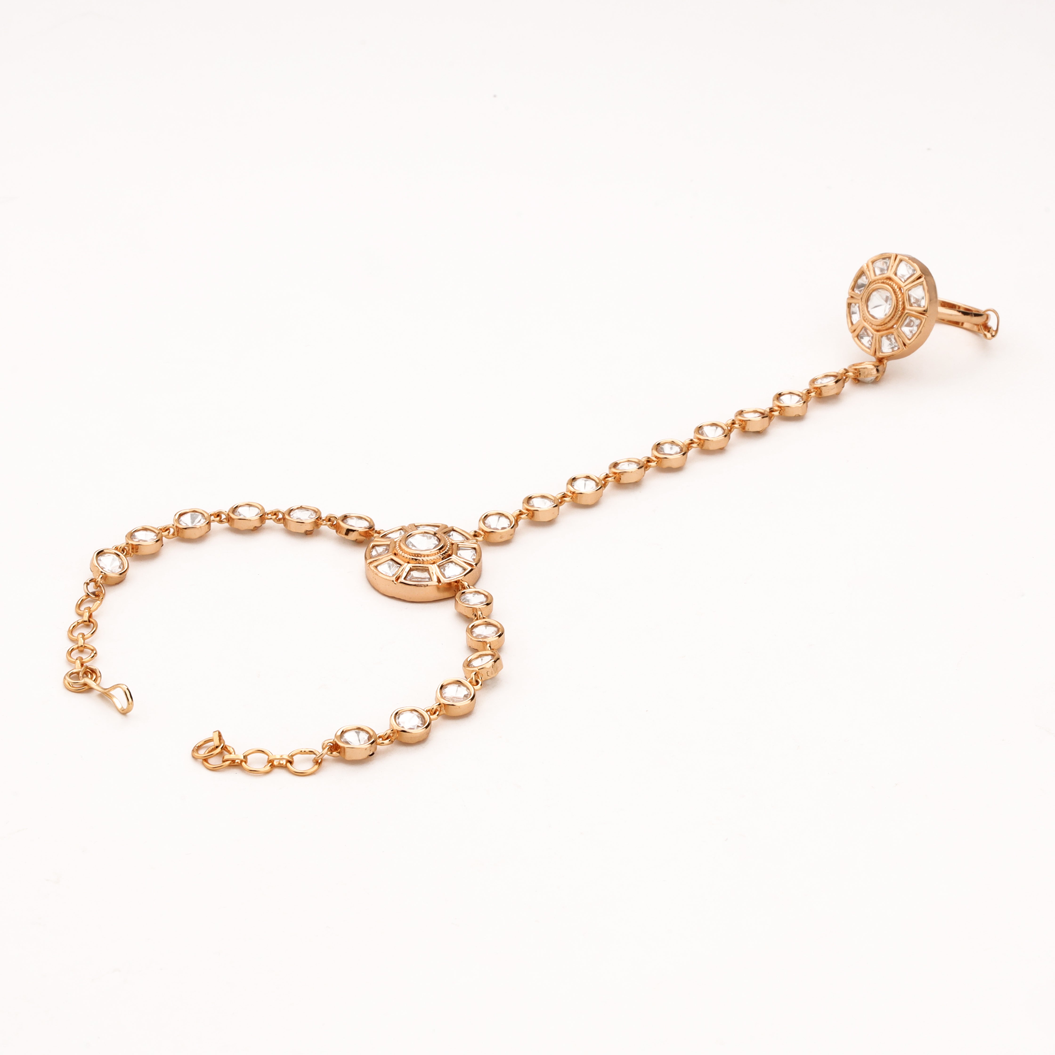 Rose gold circular kundan pocha with white oval stone links, statement finger ring and adjustable wrist chain