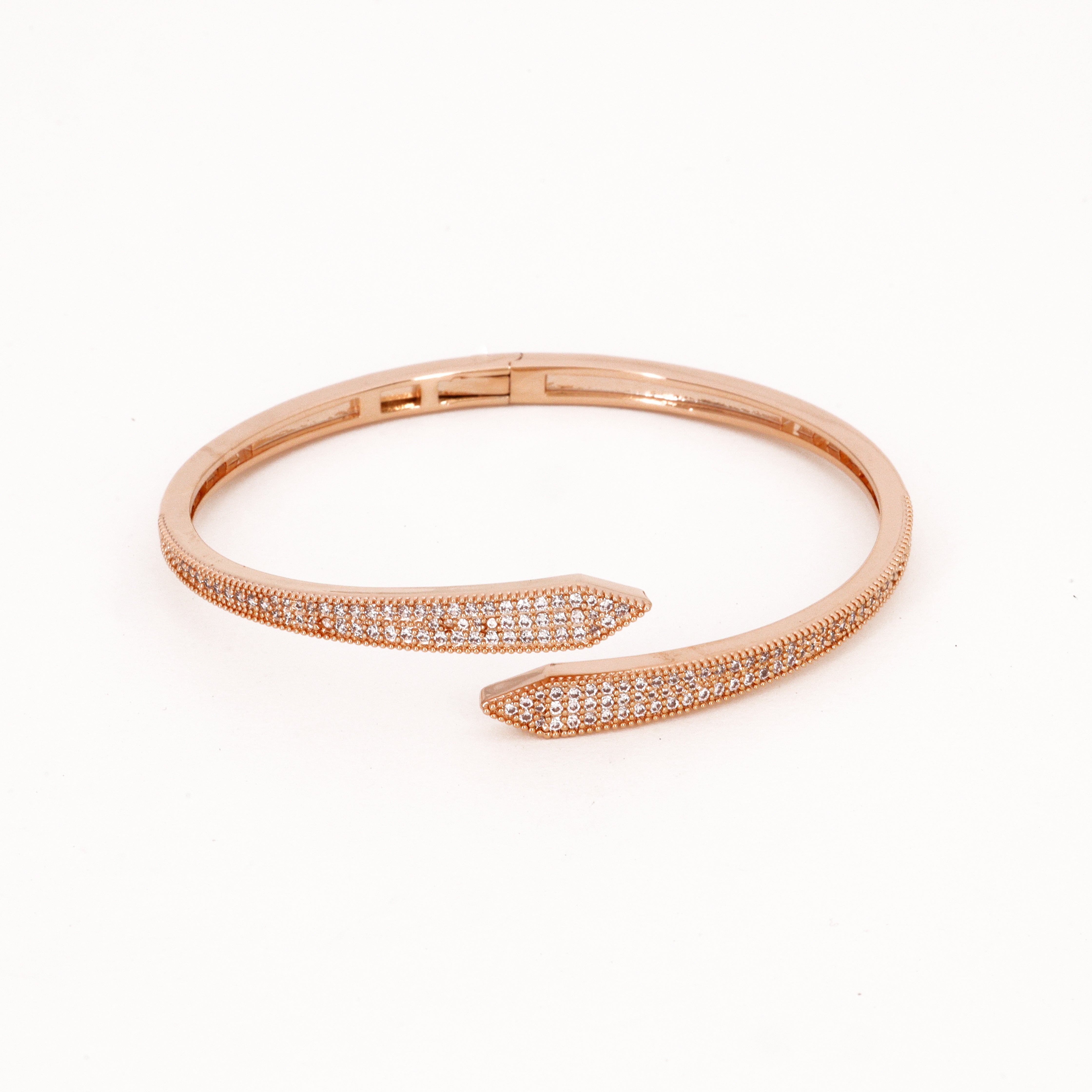 Rose Gold Crystal Arrow Bypass Bangle Bracelet featuring an overlapping pointed chevron design encrusted with clear pavé stones on a white background