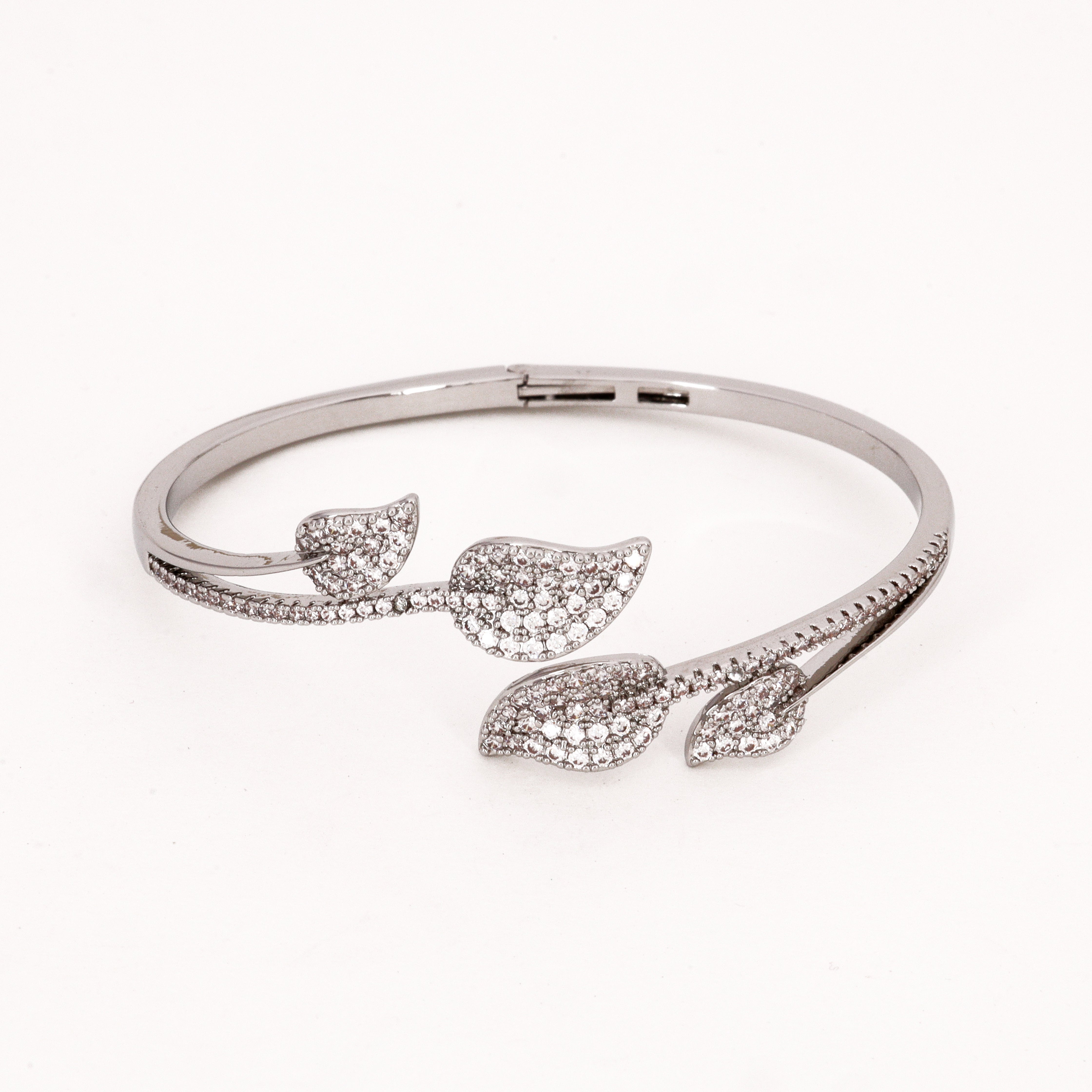 Silver Tone Crystal Leaf Bypass Bracelet featuring an overlapping vine design with pavé crystal leaf motifs on a white background