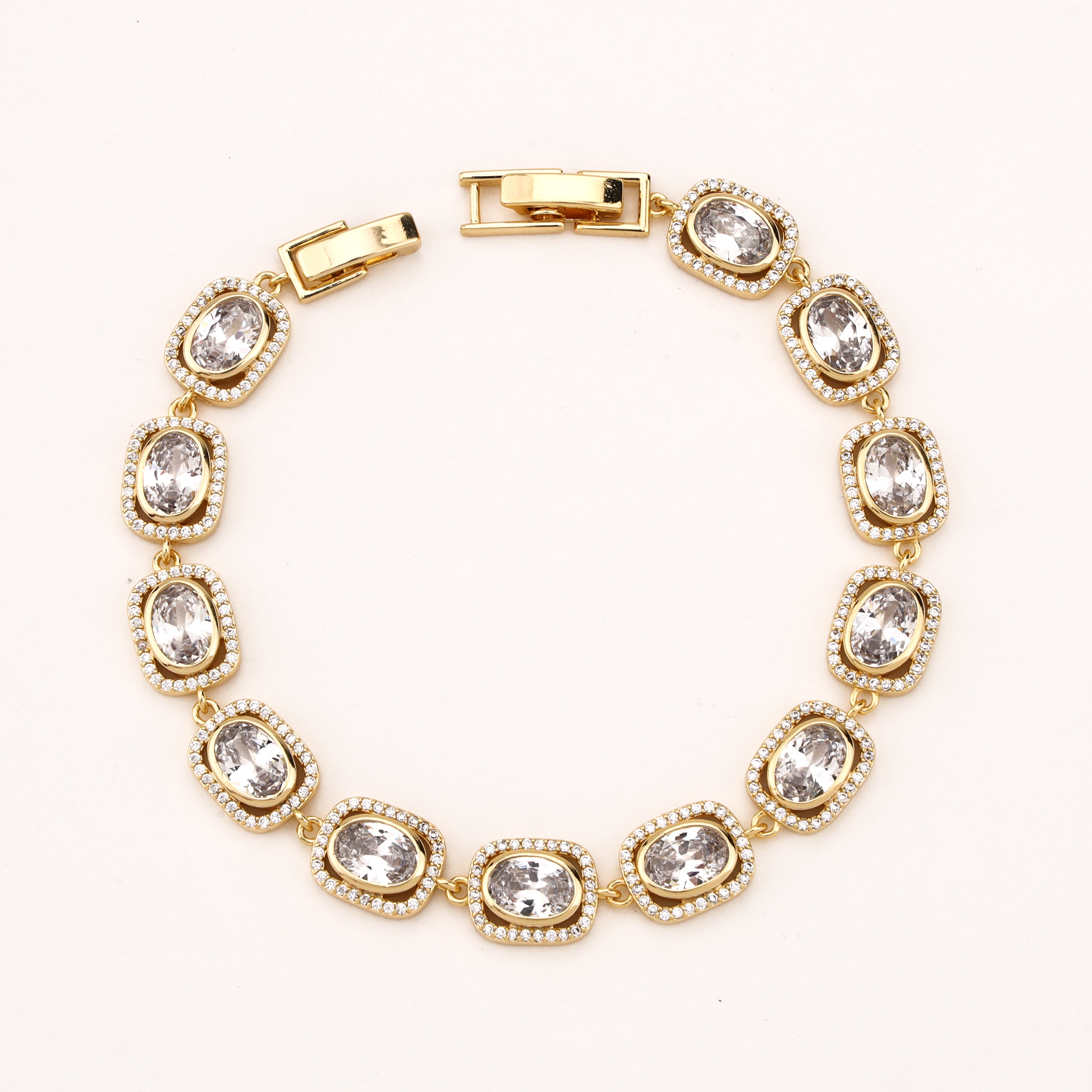 Aveline gold-tone bracelet with oval clear crystals, sparkling halo borders and linked settings