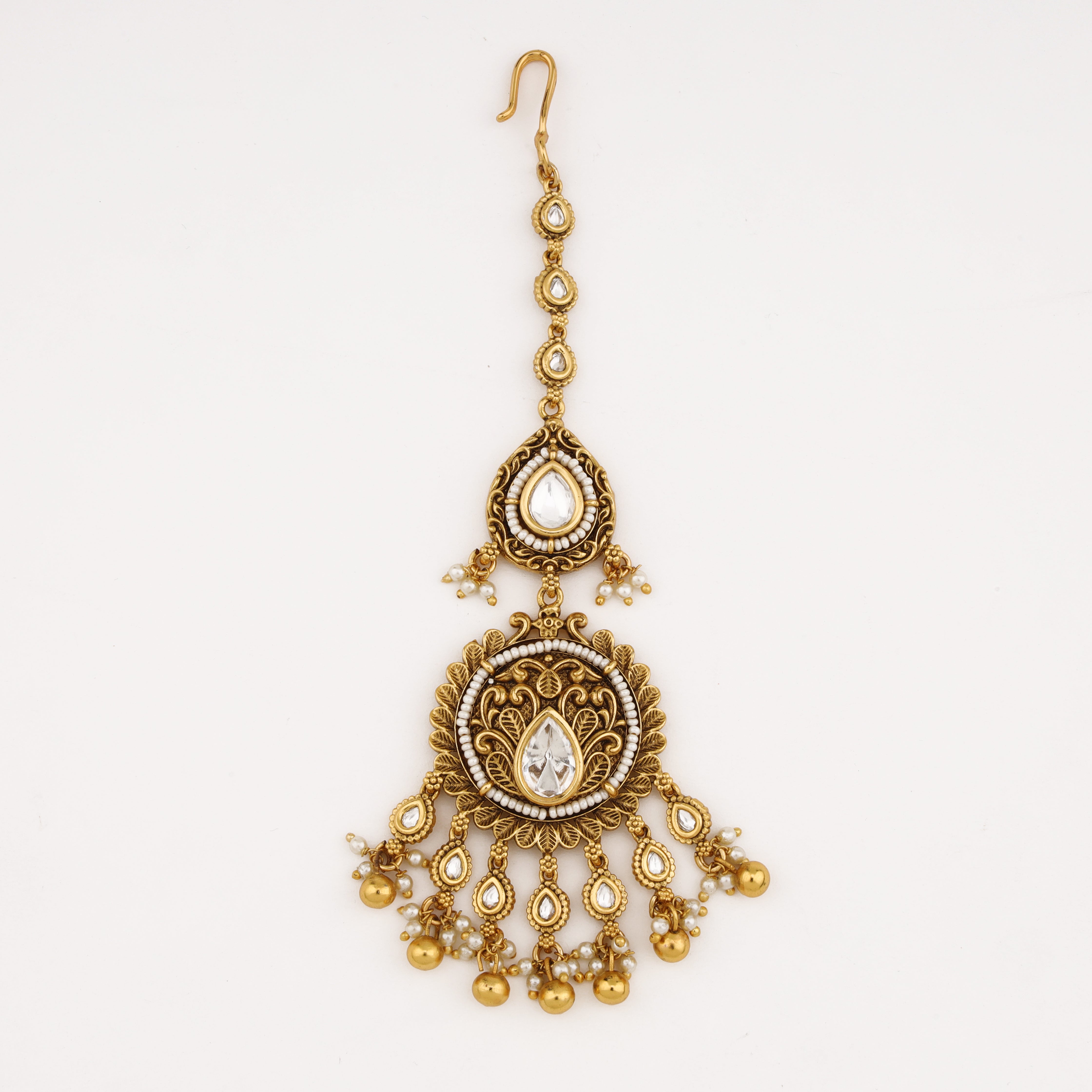 Diamond Heritage Pearl Maang Tika featuring antique gold finish, white kundan stones, pearl detailing and gold bead danglers by US Catalog