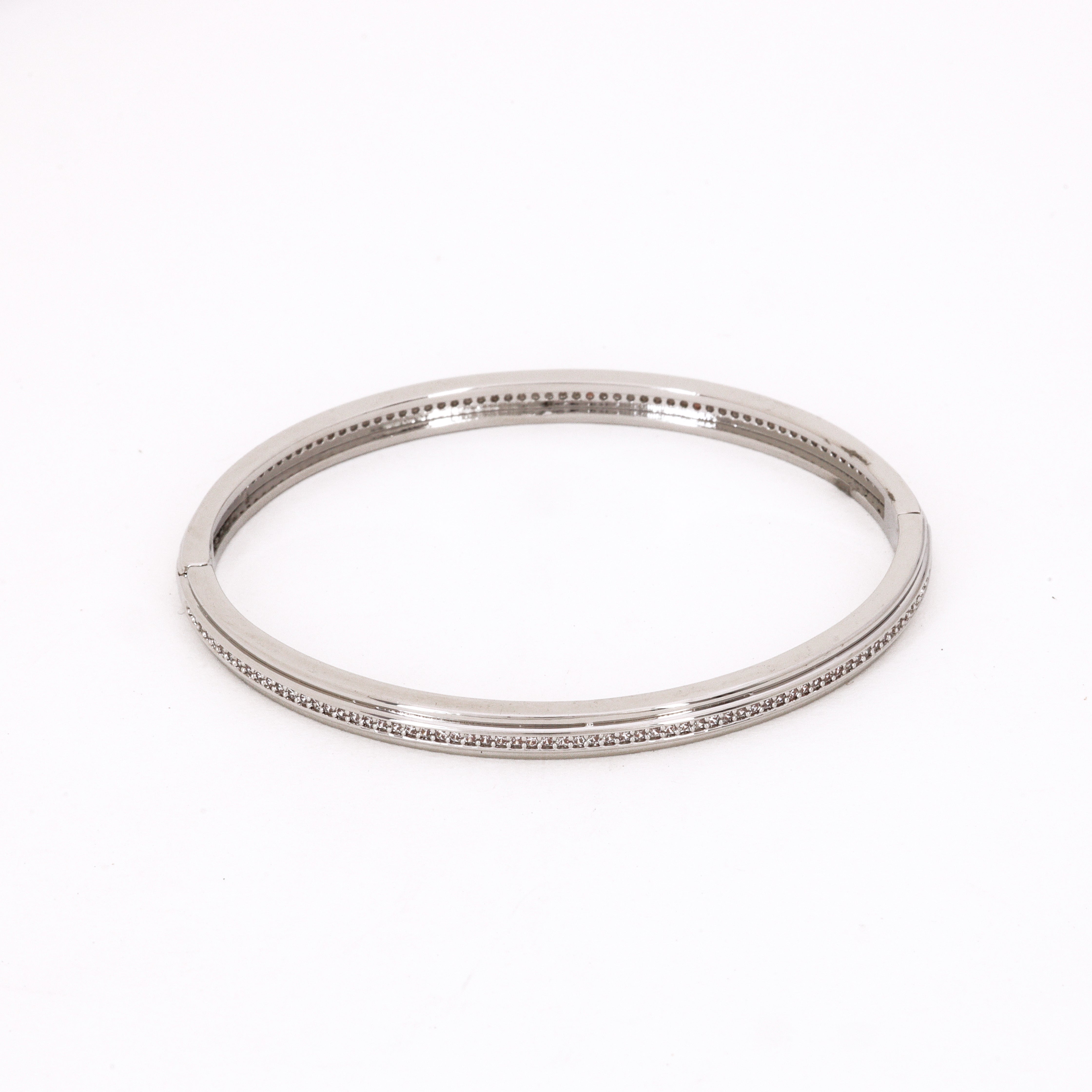 Silver Tone Single Row Pavé Bracelet featuring a sleek band and a continuous line of clear crystals on a white background for US Catalog.