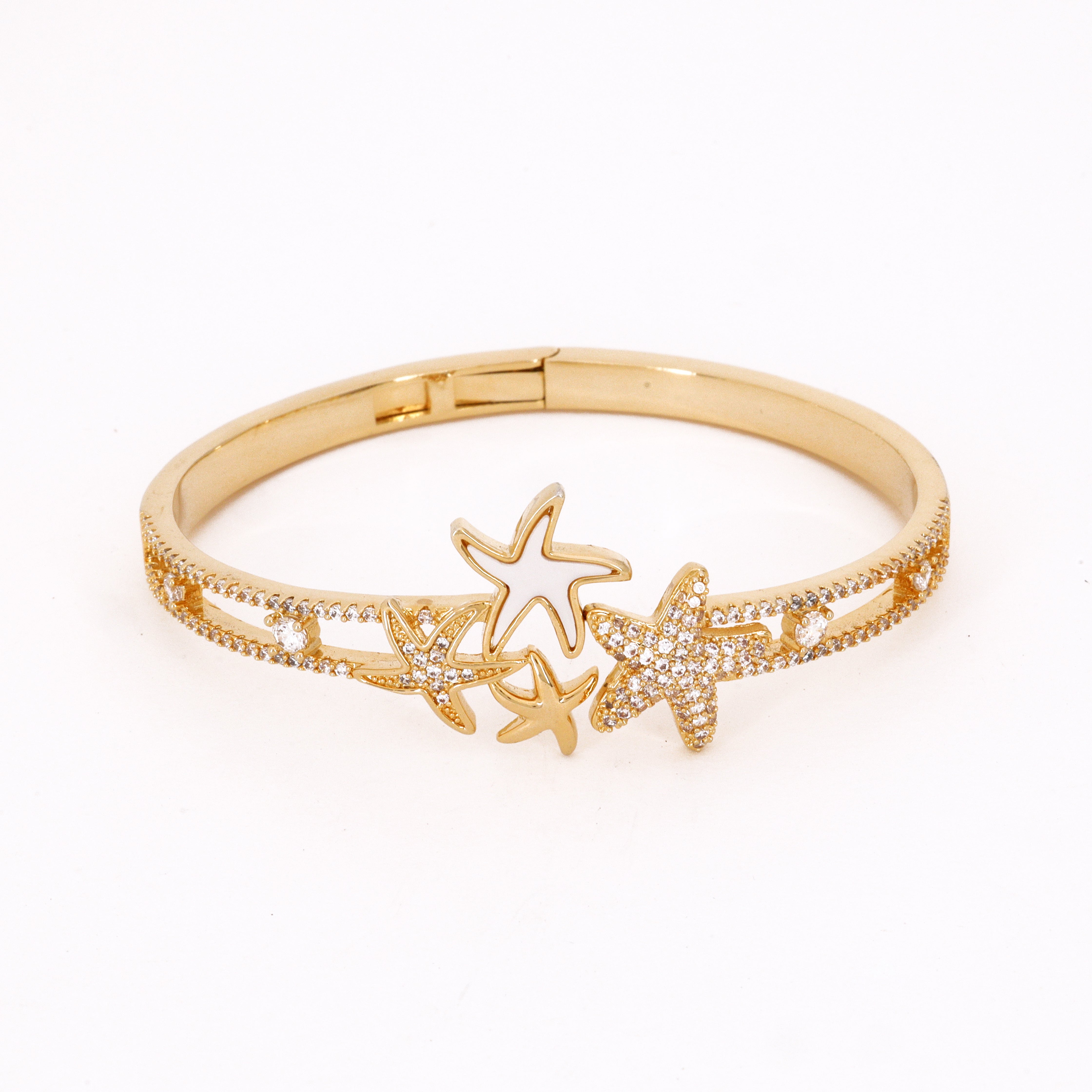 Gold Tone Starfish Cluster Bracelet featuring a central trio of starfish motifs in mixed finishes on a split-row pavé band against a white background for US Catalog.