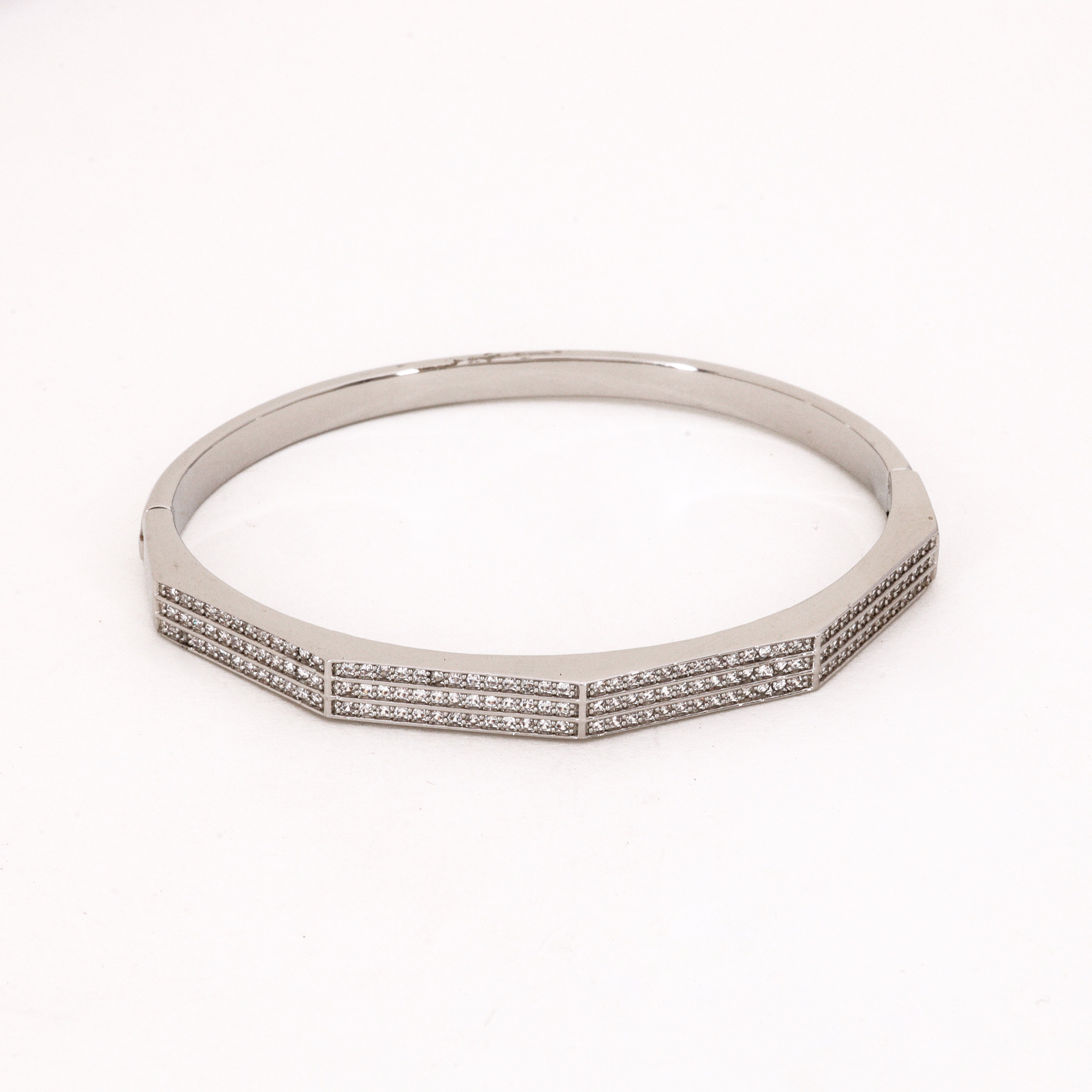 Elegant Geometric Silver Bangle with Crystals Bracelet featuring a modern architectural design with pavé crystals on a studio background.