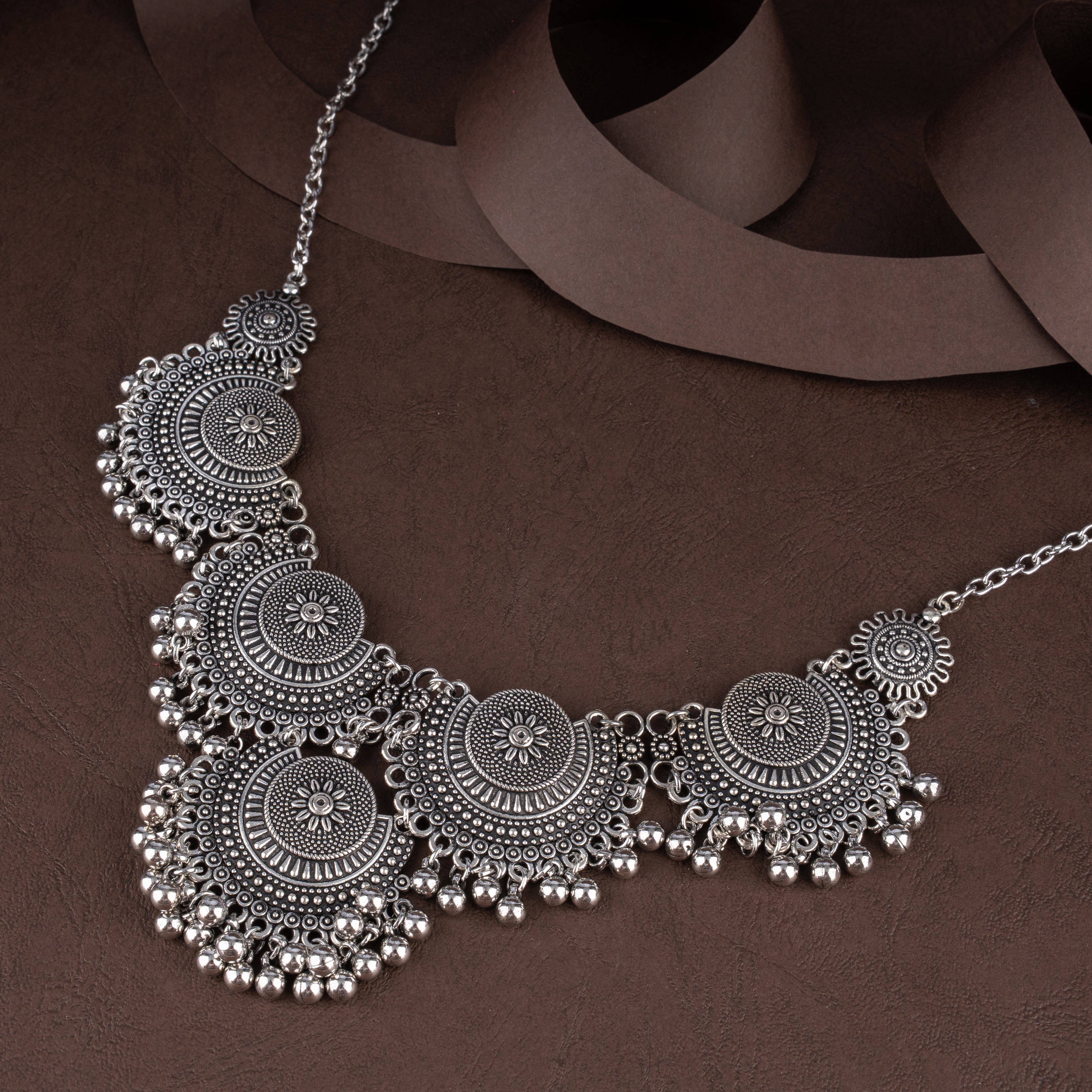 Oxidised Semicircular Sunburst Medallion Bib Necklace Set with Ghungroo Bell Fringe